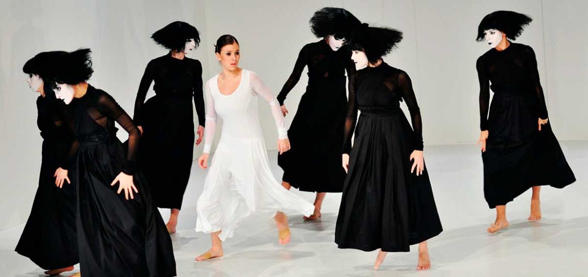 Figuras femeninoas vestidas de negro y una de blanco