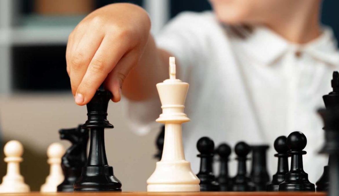 Piezas de ajedrez y una mano que las mueve