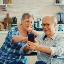 Una pareja de personas mayores consultan un móvil